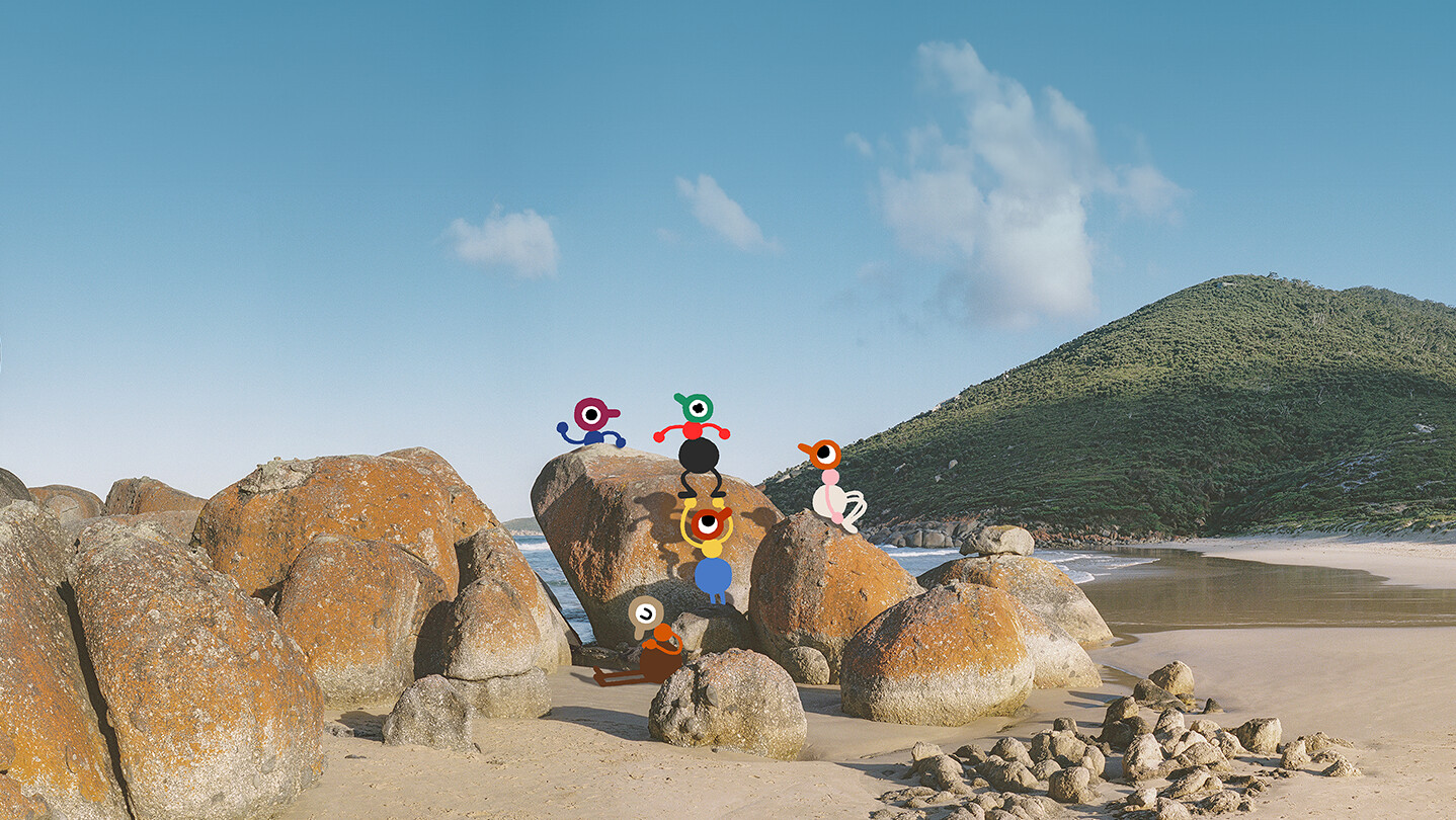 Big Walk characters exploring a sunny beach filled with large rocks