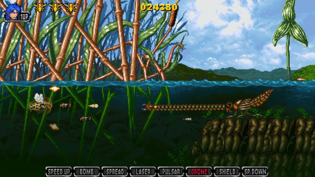 Apidya' Special underwater gameplay showing the bee protagonist battling a giant aquatic larva boss, with water surface, reeds, and submerged terrain visible