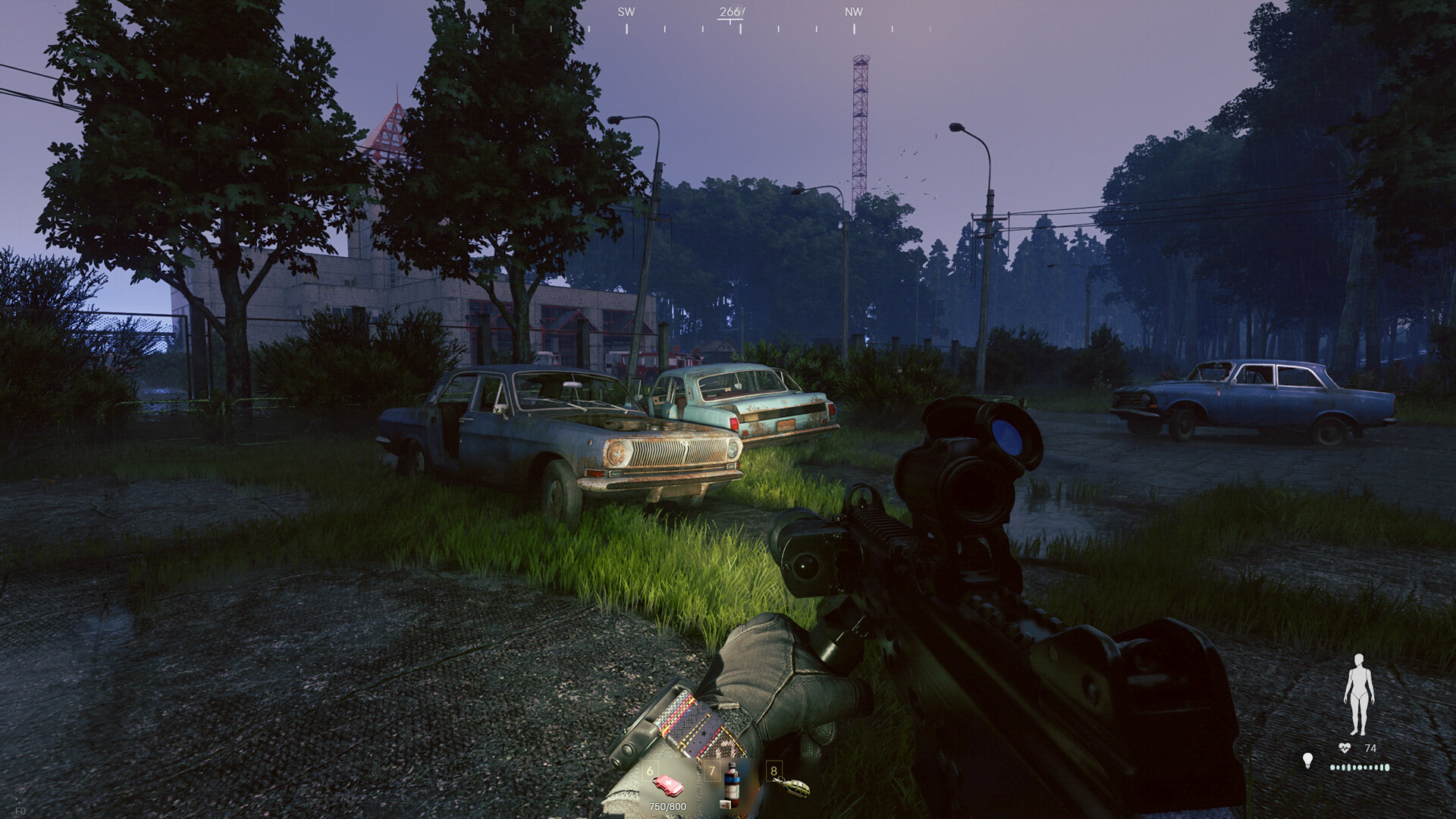 A dark, rainy road near a fenced compound with abandoned cars and tactical military atmosphere