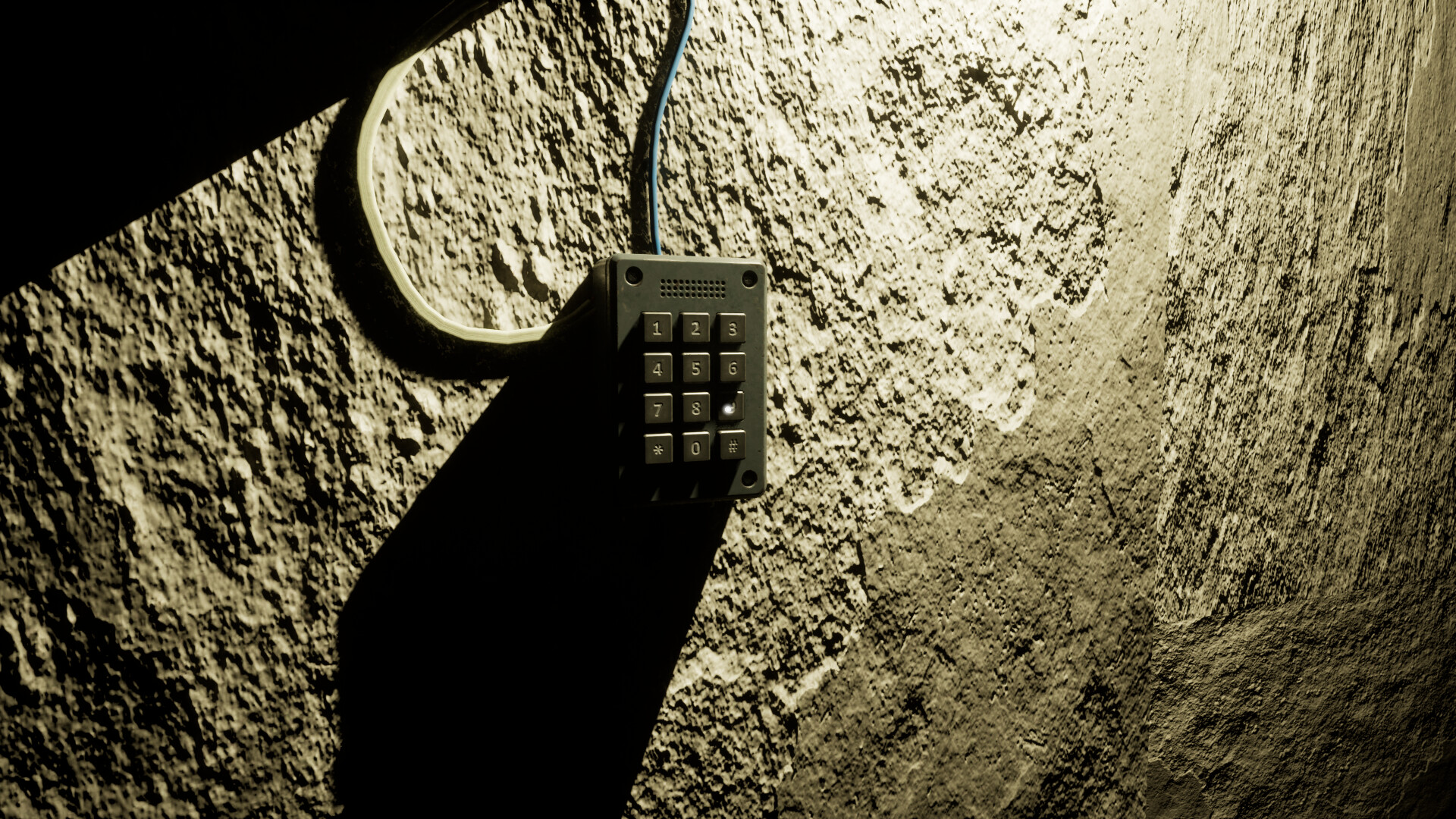 Black numeric keypad wired to a rough concrete wall under harsh light