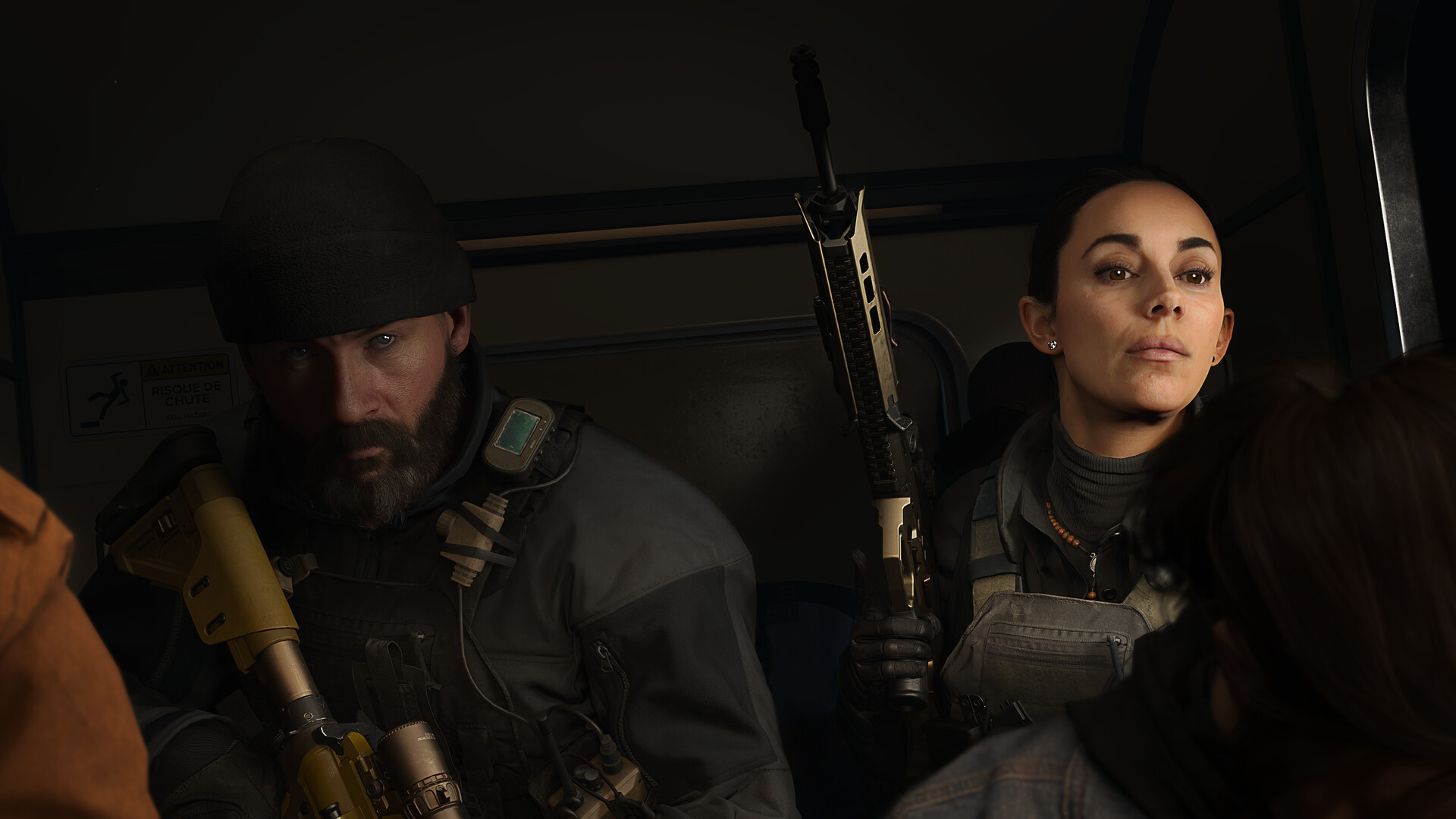 Call of Duty: Modern Warfare 4 narrative cutscene with two key characters riding in a dark transport vehicle